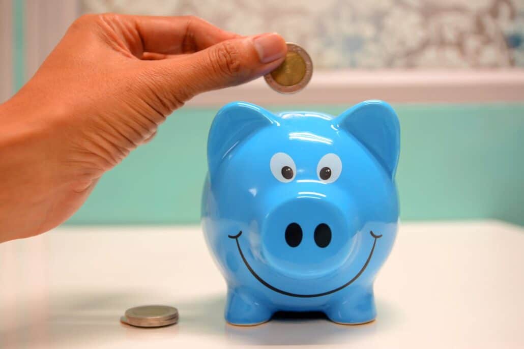 coin-being-put-in-blue-piggy-bank | Specialized Indianapolis coin being put in blue piggy bank